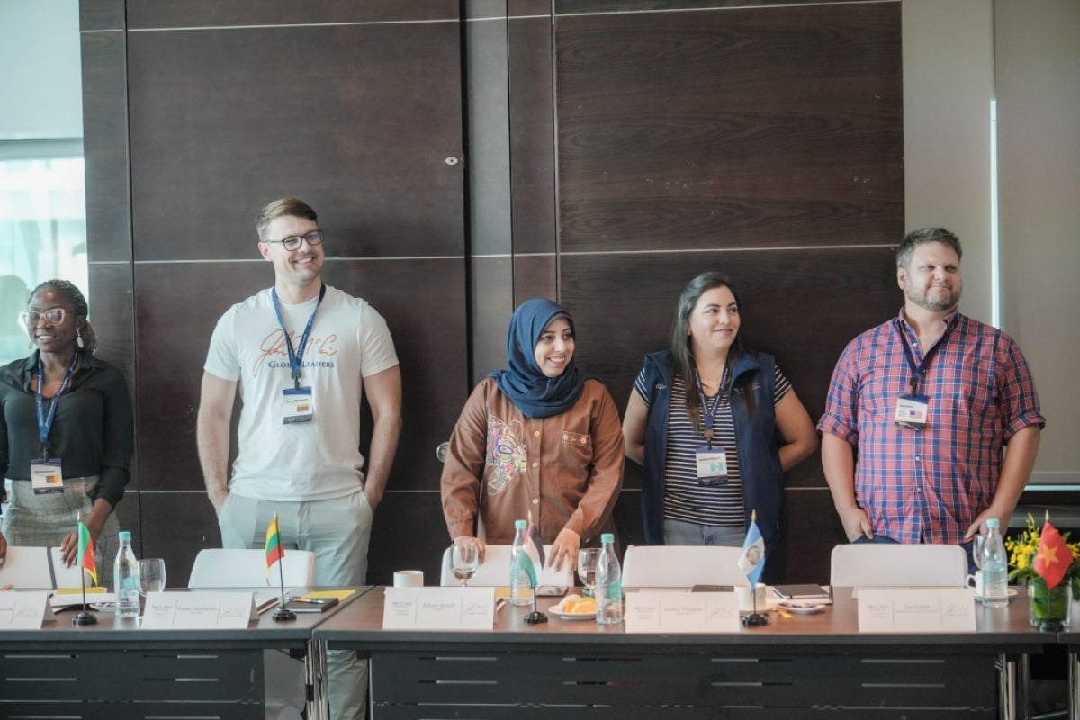 MGLs Zyh Akumahwah, Tomas Martinaitis, Reham AlSaidi, Andrea Villagrán and Global Advisory Council Member David Kirk at welcome discussion, standing in a line.