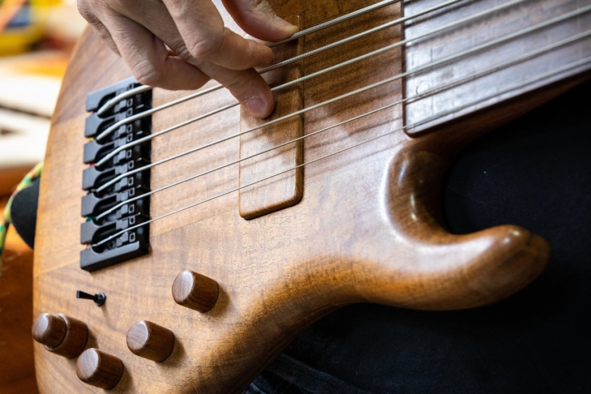 Detail of wood craft on body of finished bass