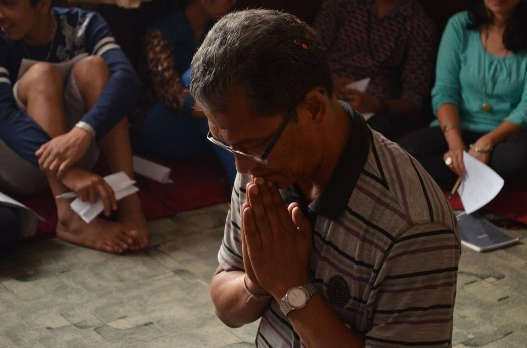 Man Prays at Workshop