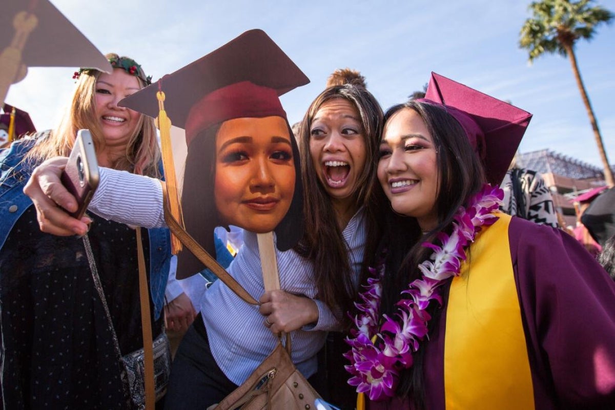 student and aunt taking selfie at graduation