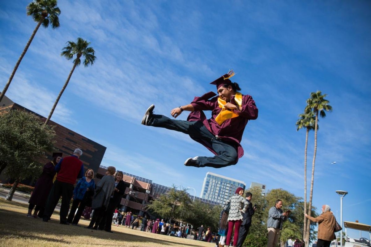 graduate jumping in the air