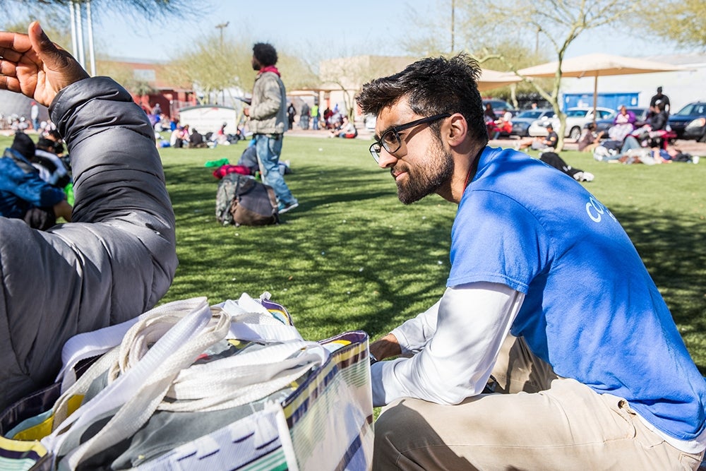 Chandan Saini talks with homeless people