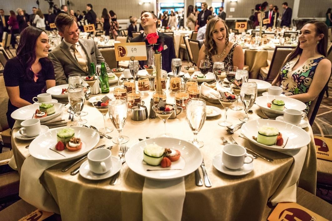 people sitting at dinner table at event