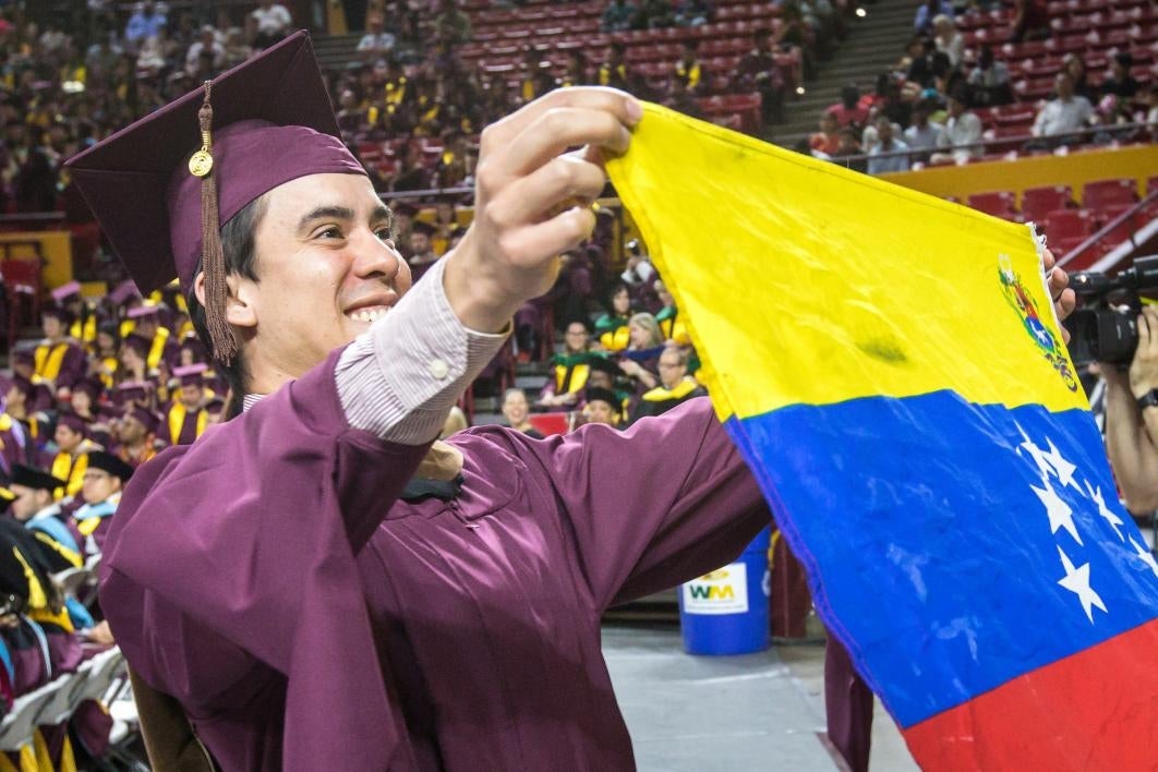 graduate holding flag