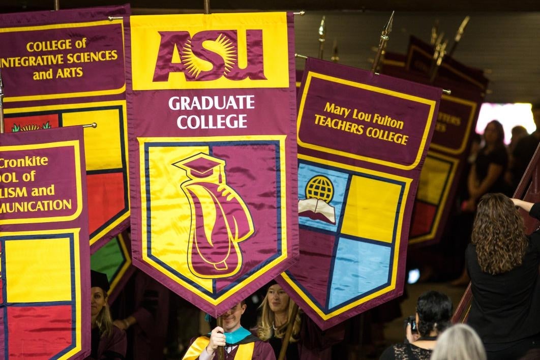 people carrying banners into graduation