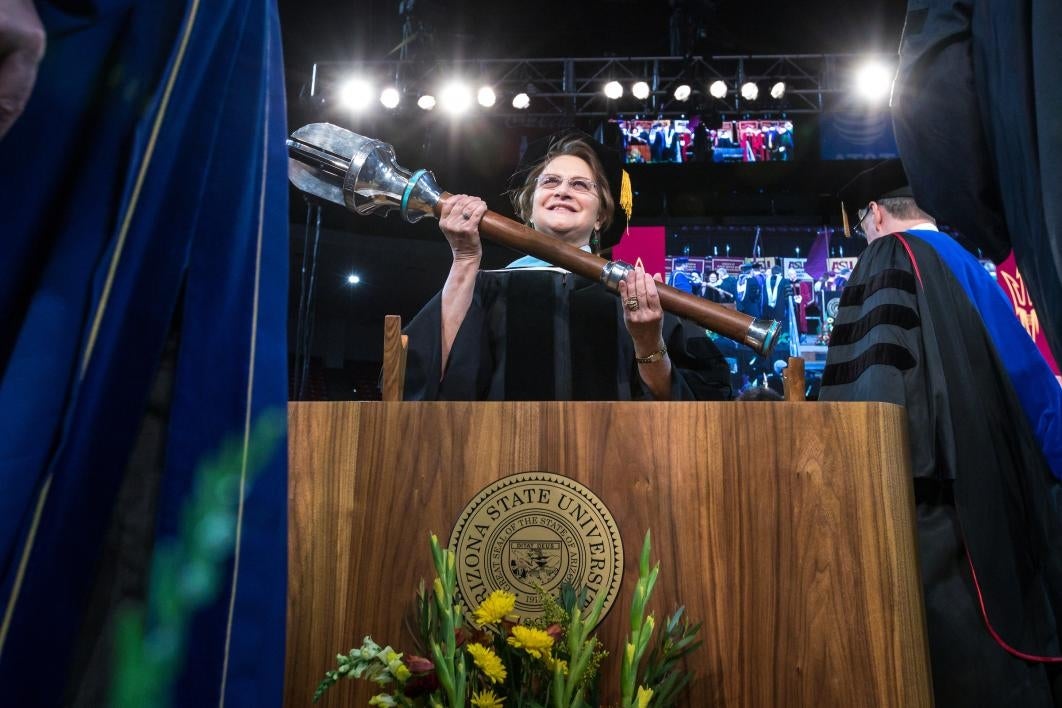 woman holding university ceremonial mace