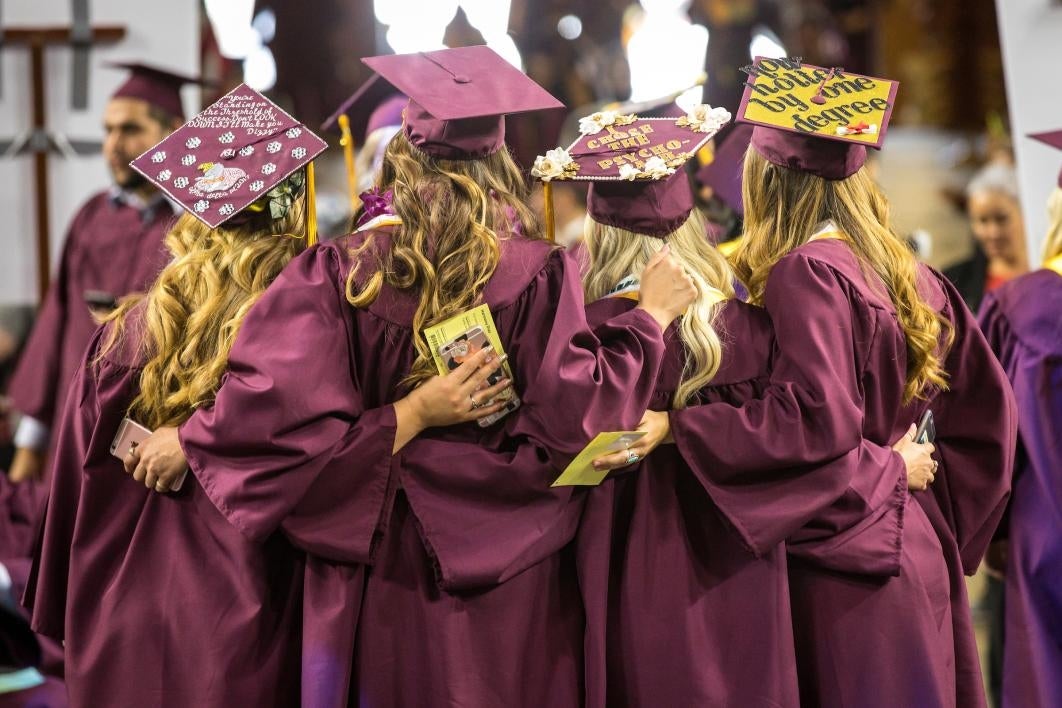 back of graduates taking group photo