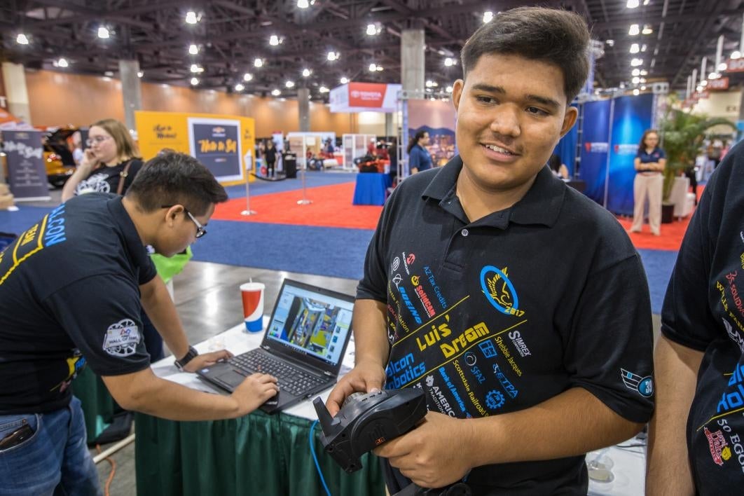 A Phoenix high schooler controls a robot at National Council of La Raza