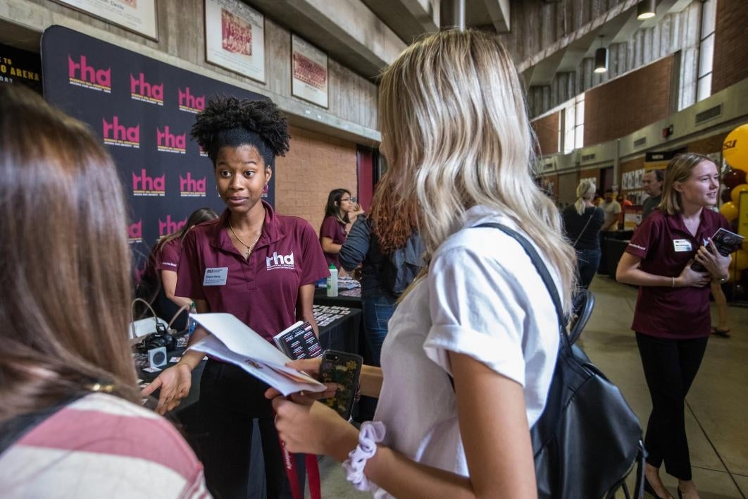 Students pick up their room keys and information at Wells Fargo Arena