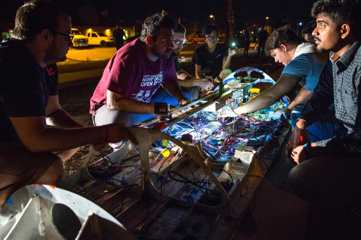 The AZLoop team works on the chassis in the pre-dawn