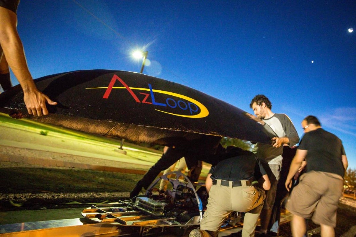 AZLoop team lifts the cover onto the pod