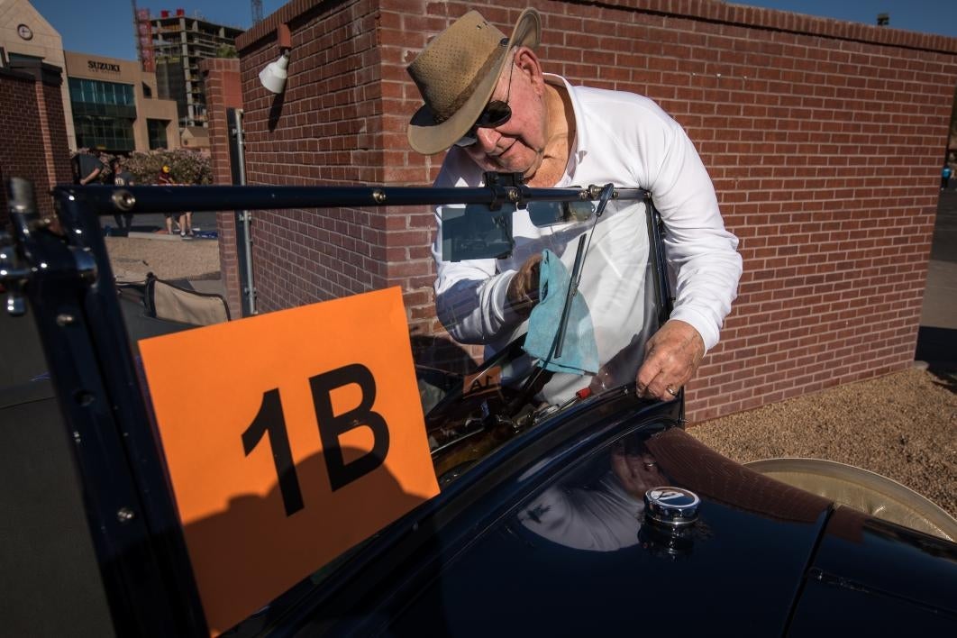 man cleaning car window