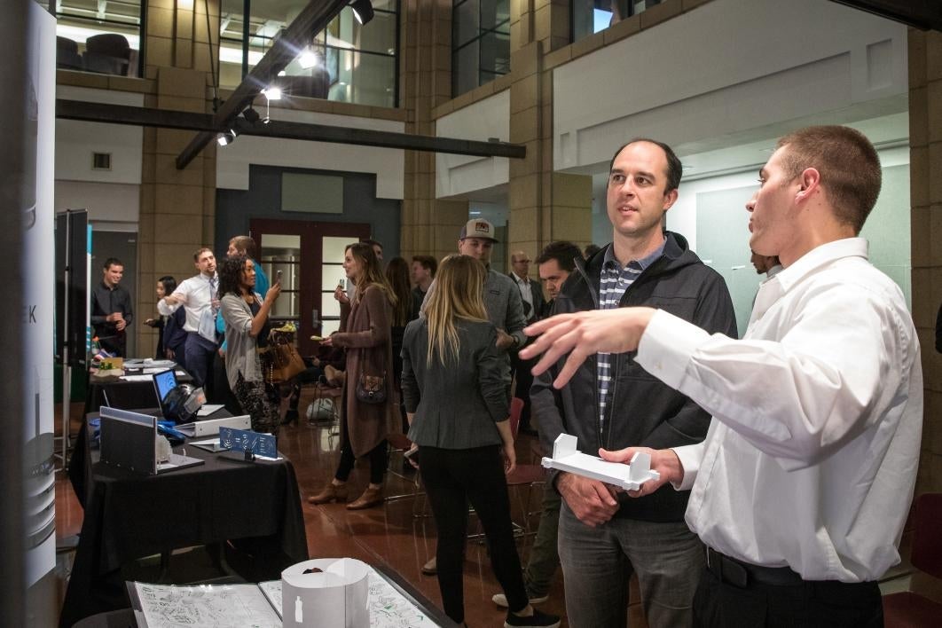 two people talking at exhibit