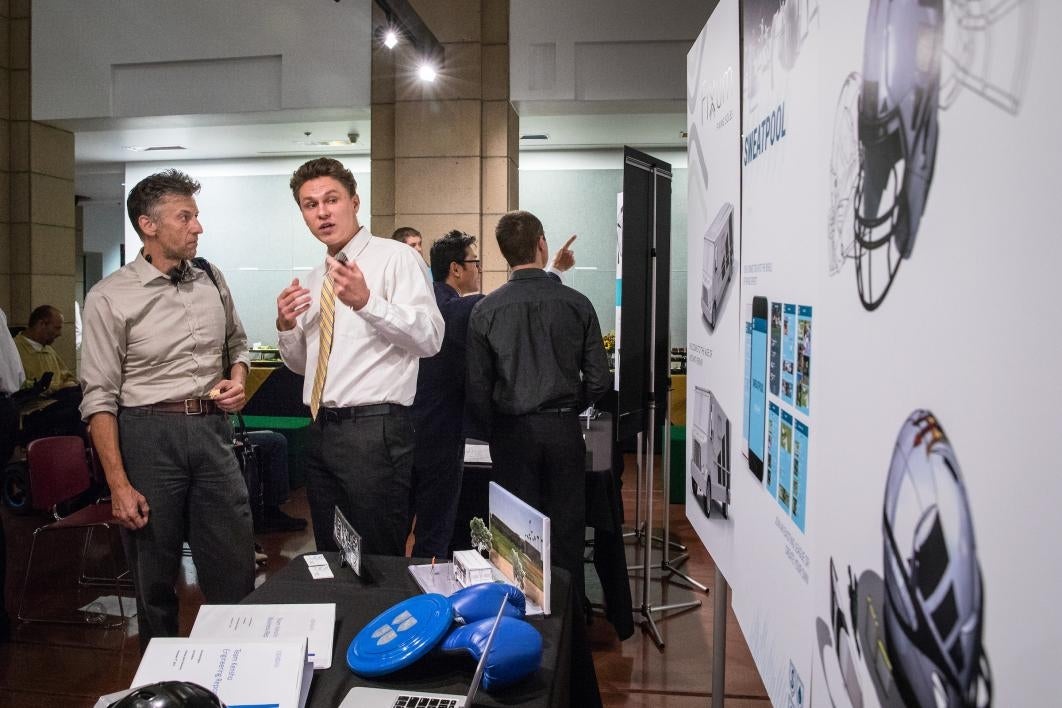 two people talking at exhibition