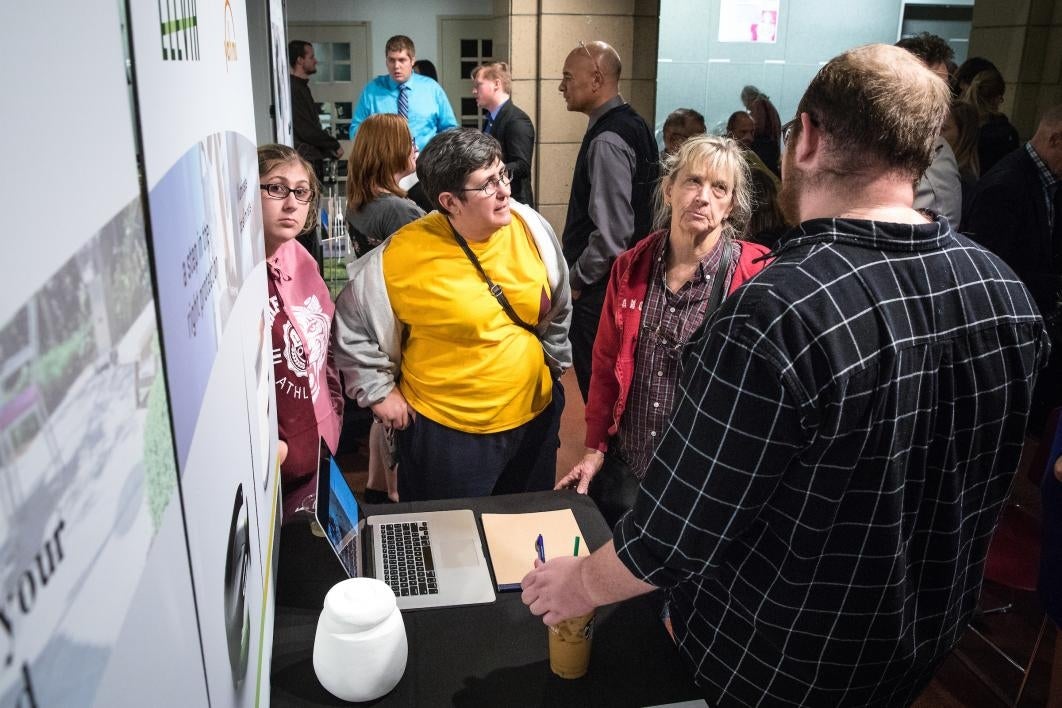 people talking at exhibition