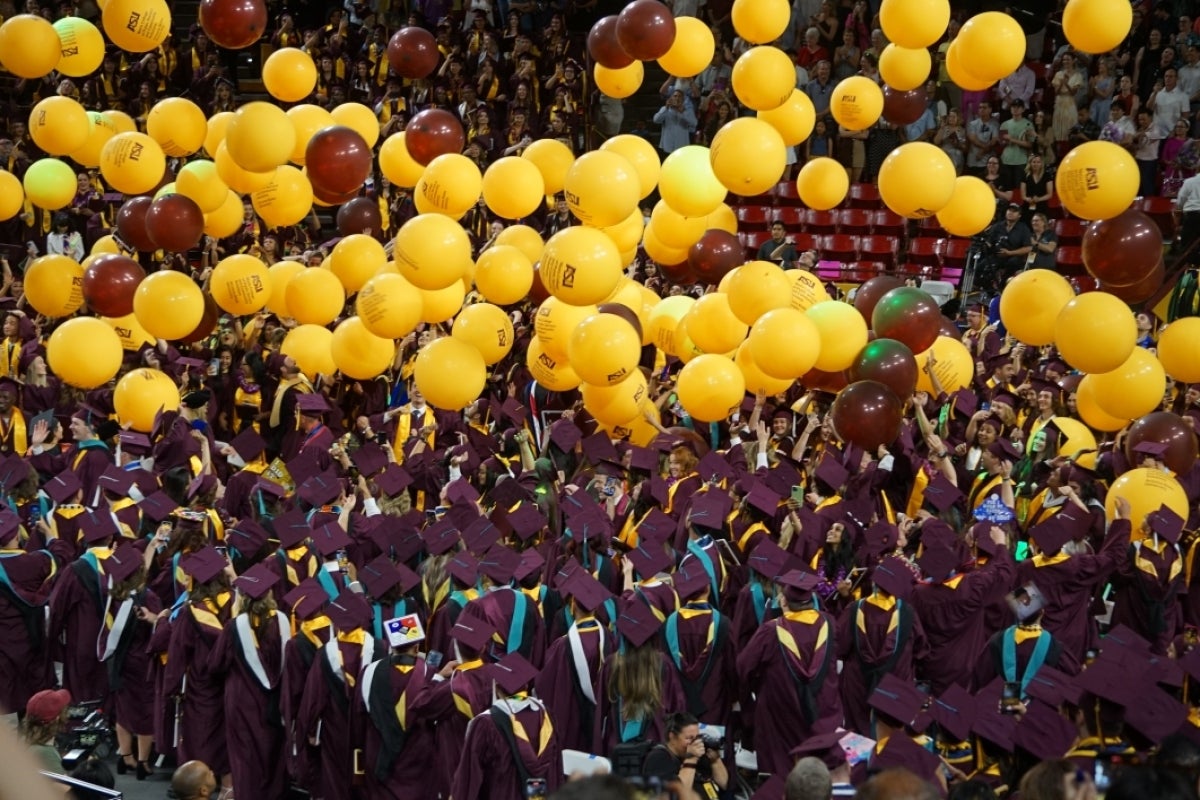 Balloons fall from rafters of Desert Financial Arena at Watts College of Public Service and Community Solutions spring 2023 convocation