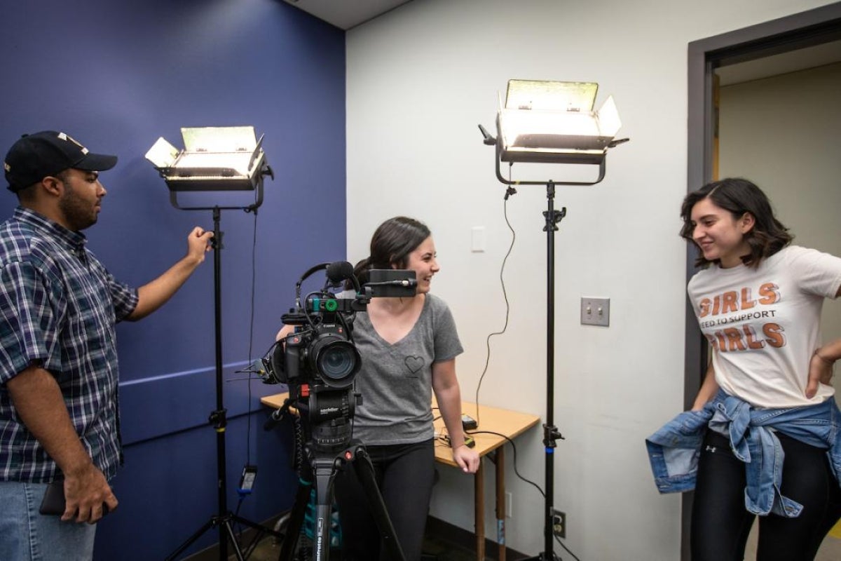 Camera crew lighting up a room