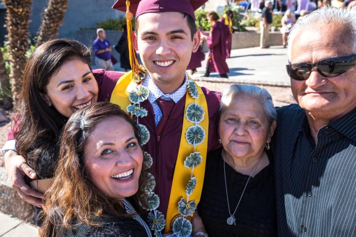 graduate posing with family