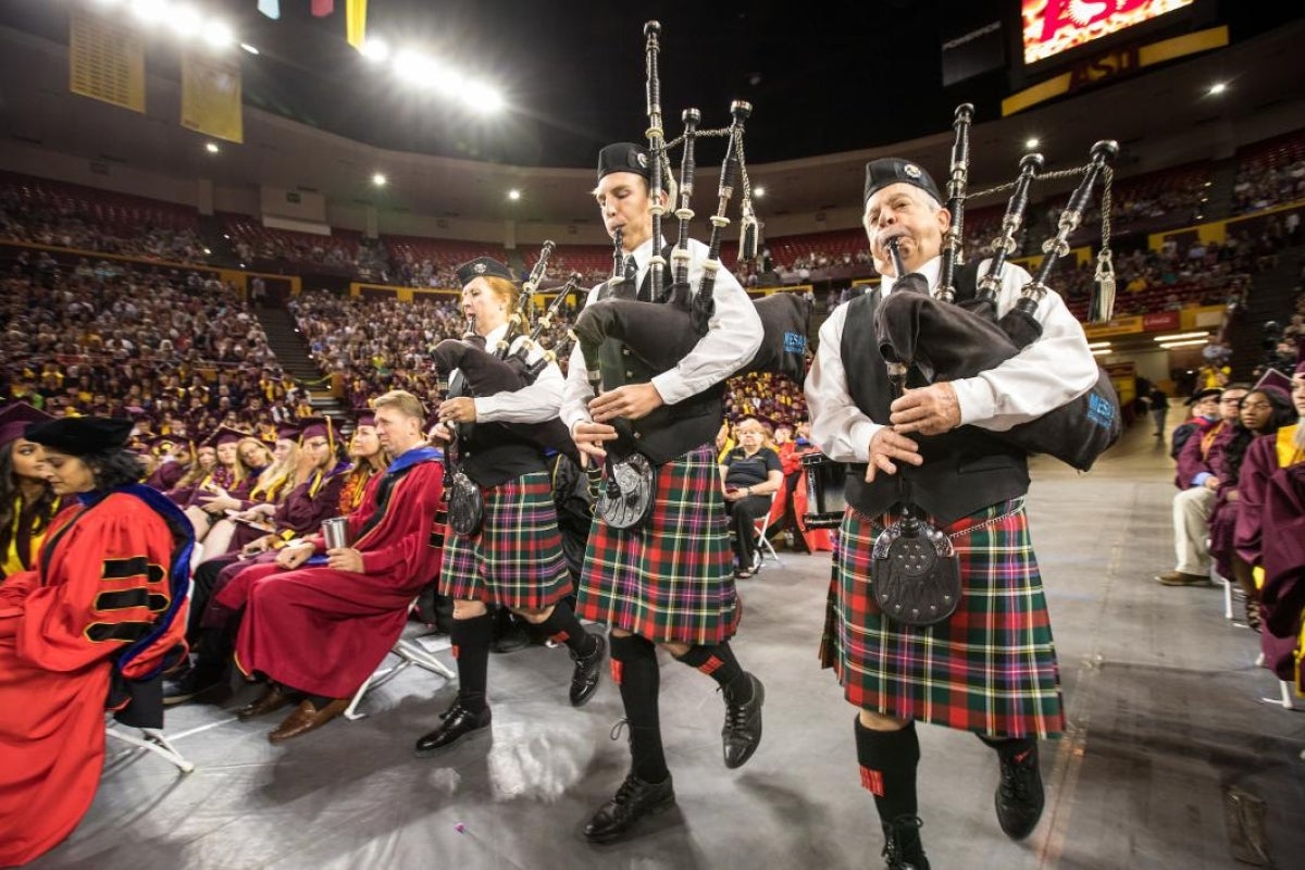 people playing bagpipes at ceremony