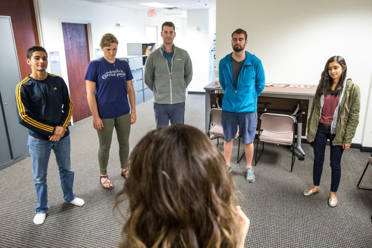 people standing in a semi circle