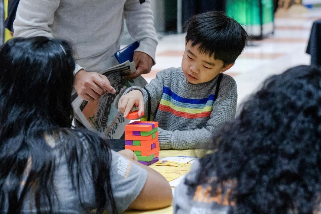 kid plays jenga