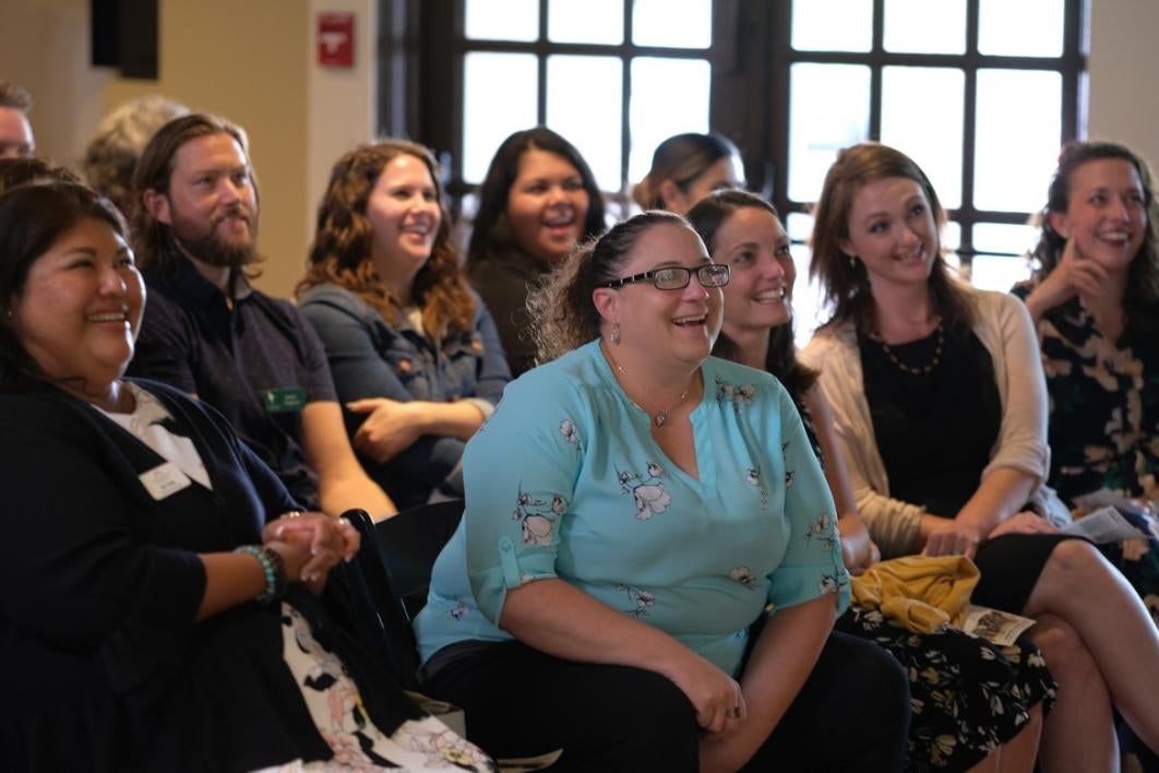 Jessica Wright and classmates laugh while watching a graduation video they produced.