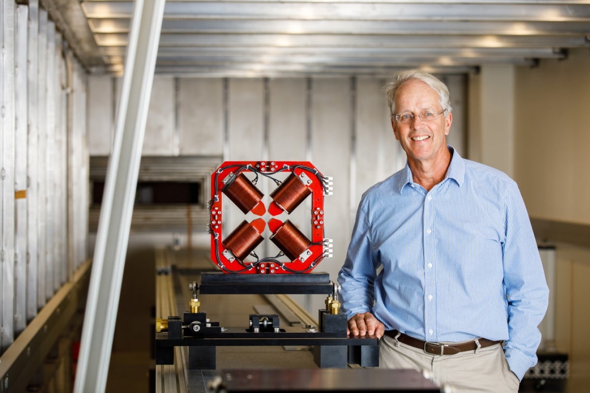 Bill Graves standing next to one of the magnets used in the building of the CXLS, a prototype instrument for the CXFEL.