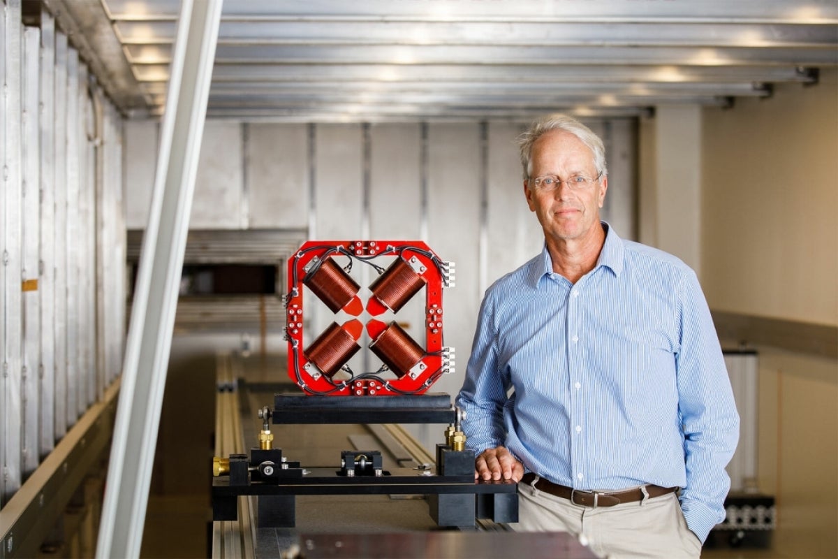 Man standing next to CXFEL component