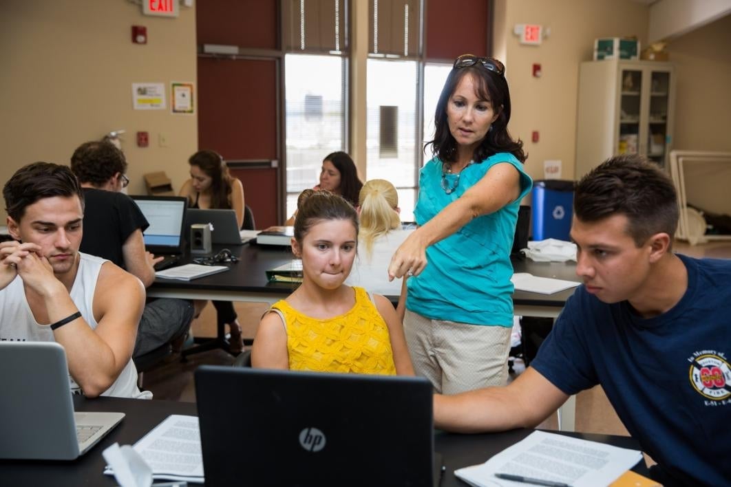 Teacher helping students learn.