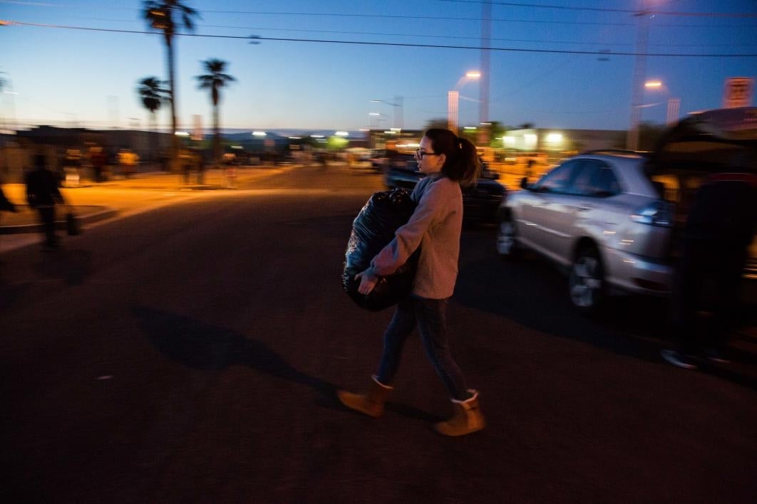 woman carrying box of donations