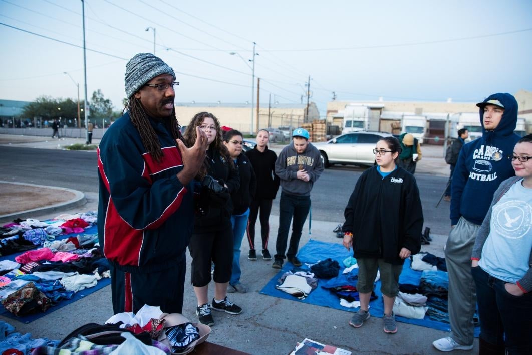 man speaking to crowd of volunteers