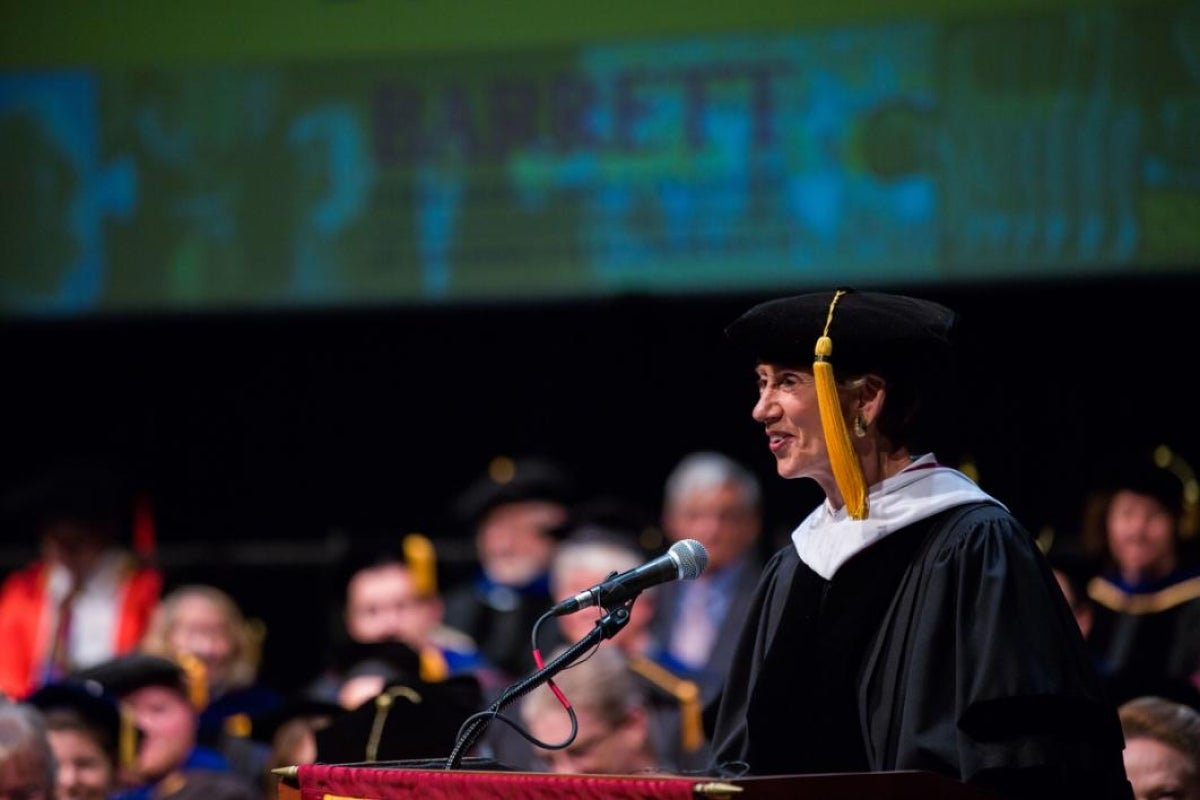 Woman speaking at a graduation.