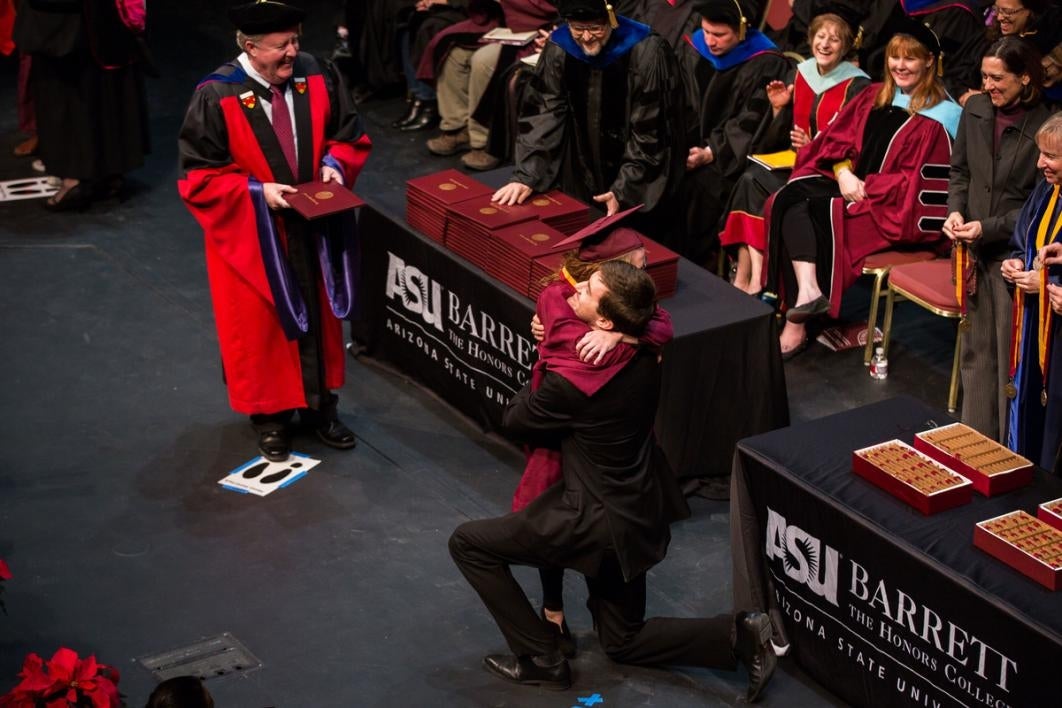 People hugging during a graduation moment.