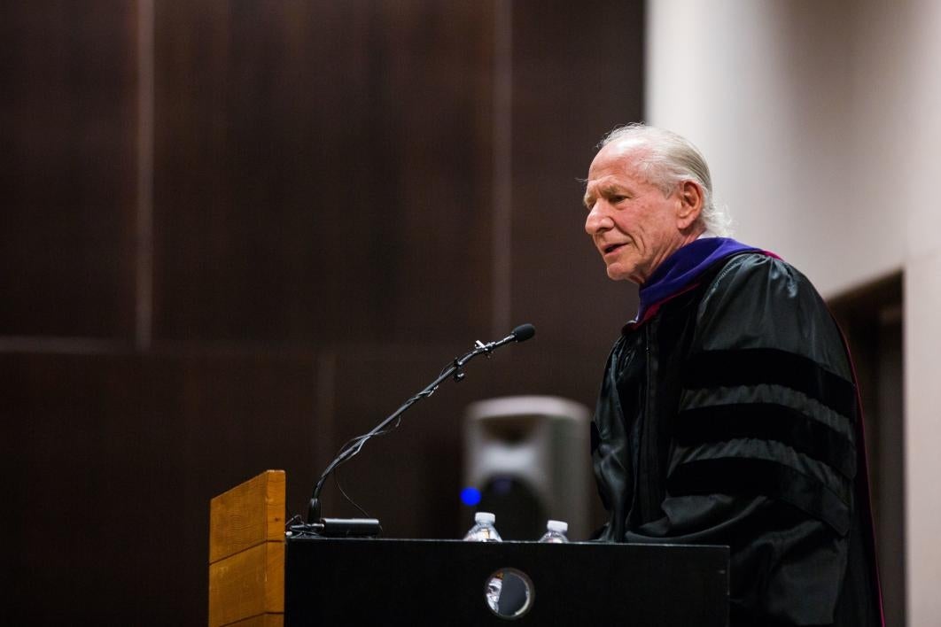 man speaking at podium