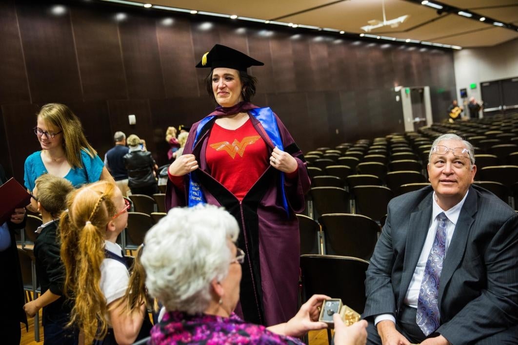 ASU law student showing Wonder Woman shirt under graduation robe