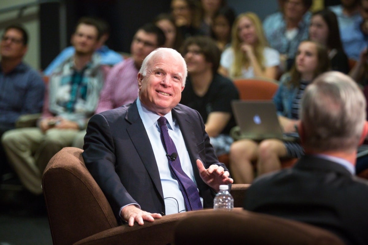 Sen. John McCain smiles as he looks up at a screen off camera