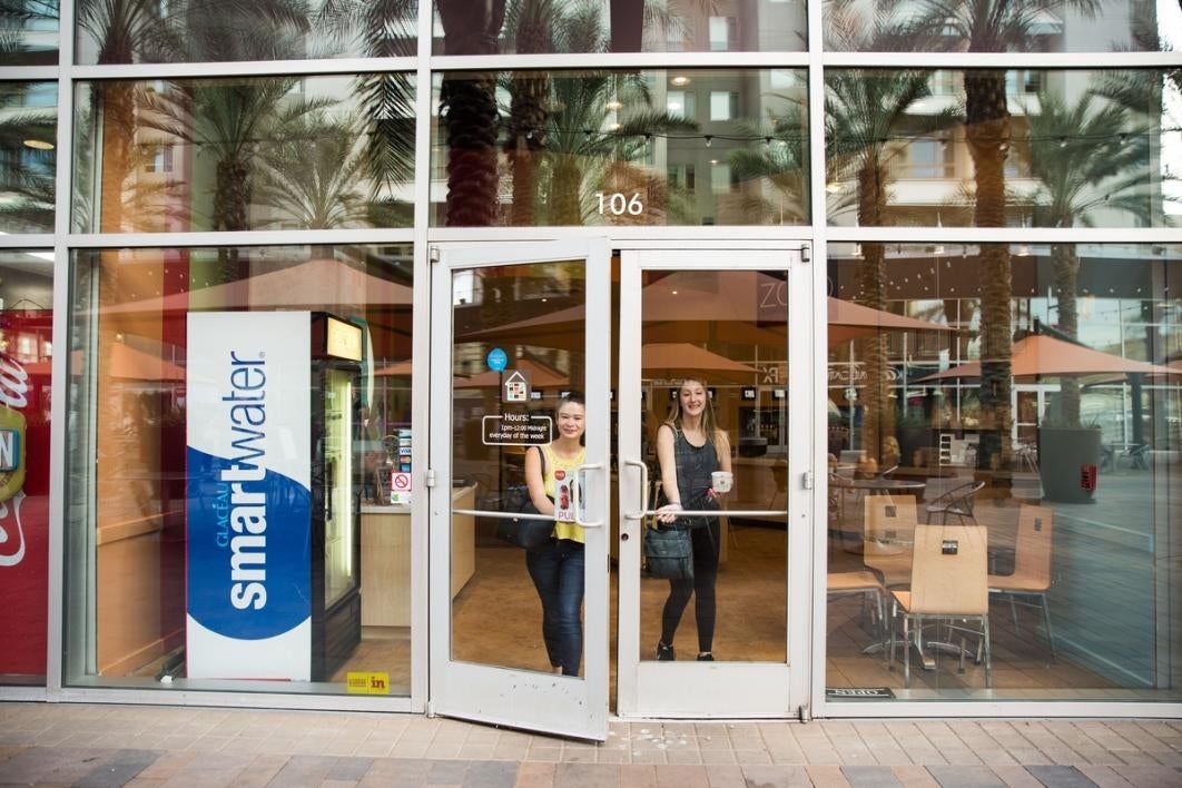 Women walking out of a store.