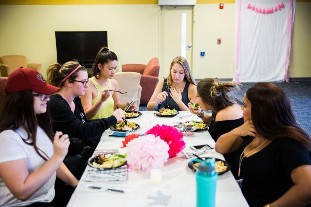 Women eating at a table.