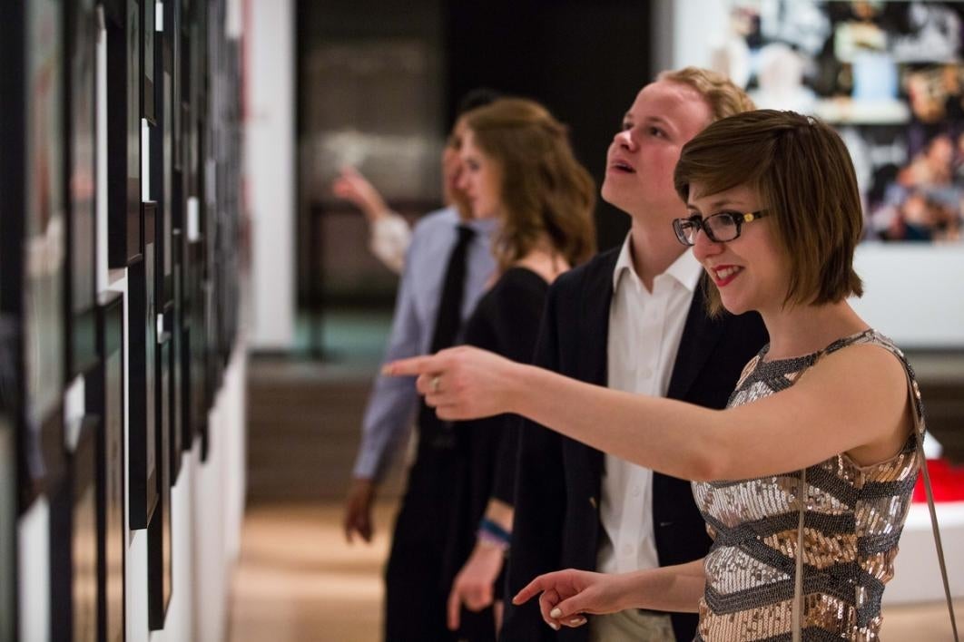 People looking at art in a museum.