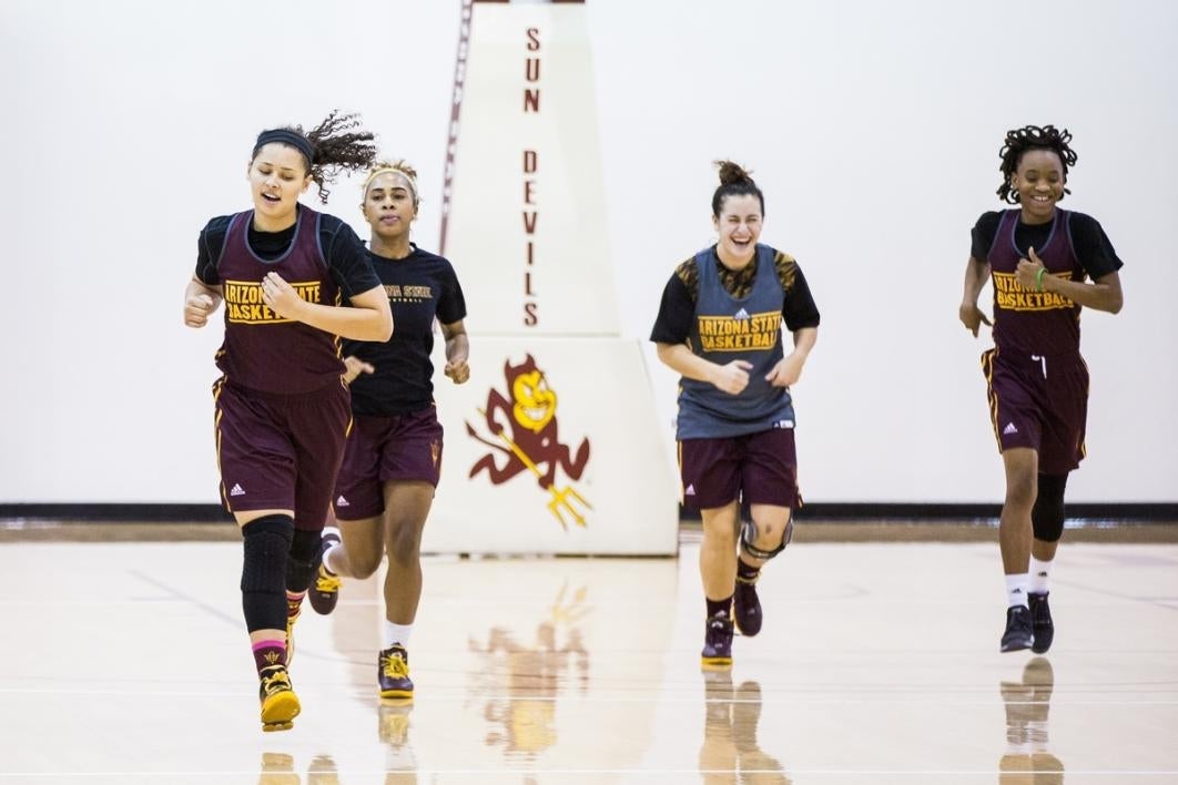 Basketball players running at practice.