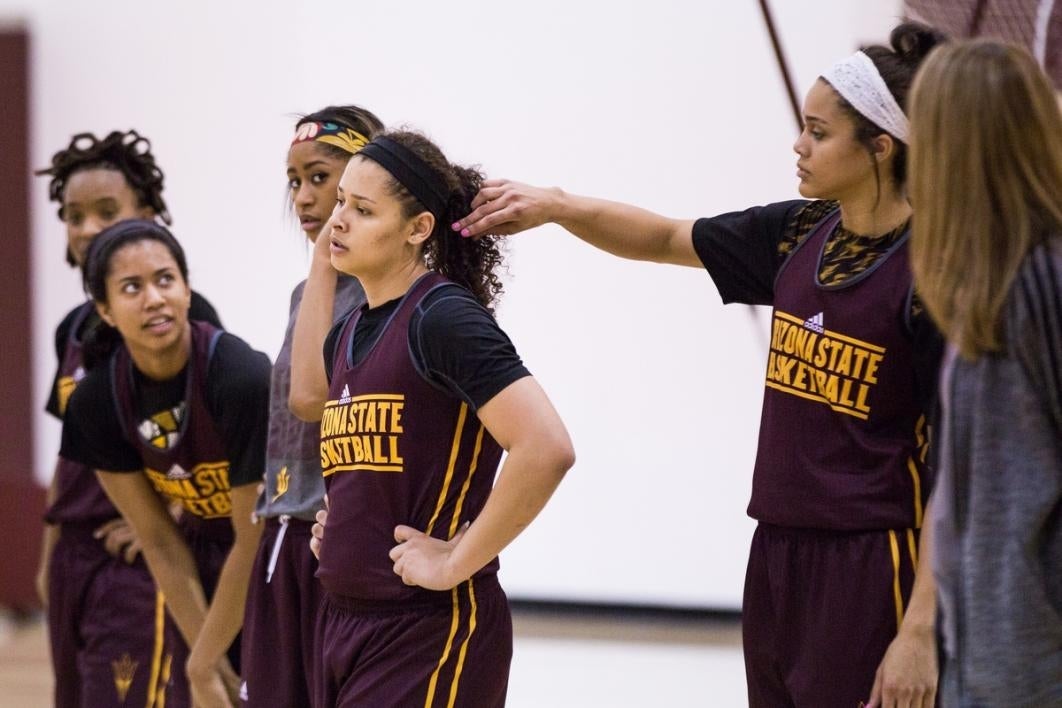 Basketball players resting during practice.