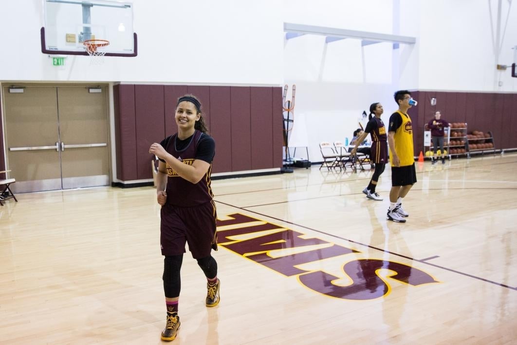 Woman walking off the basketball court.