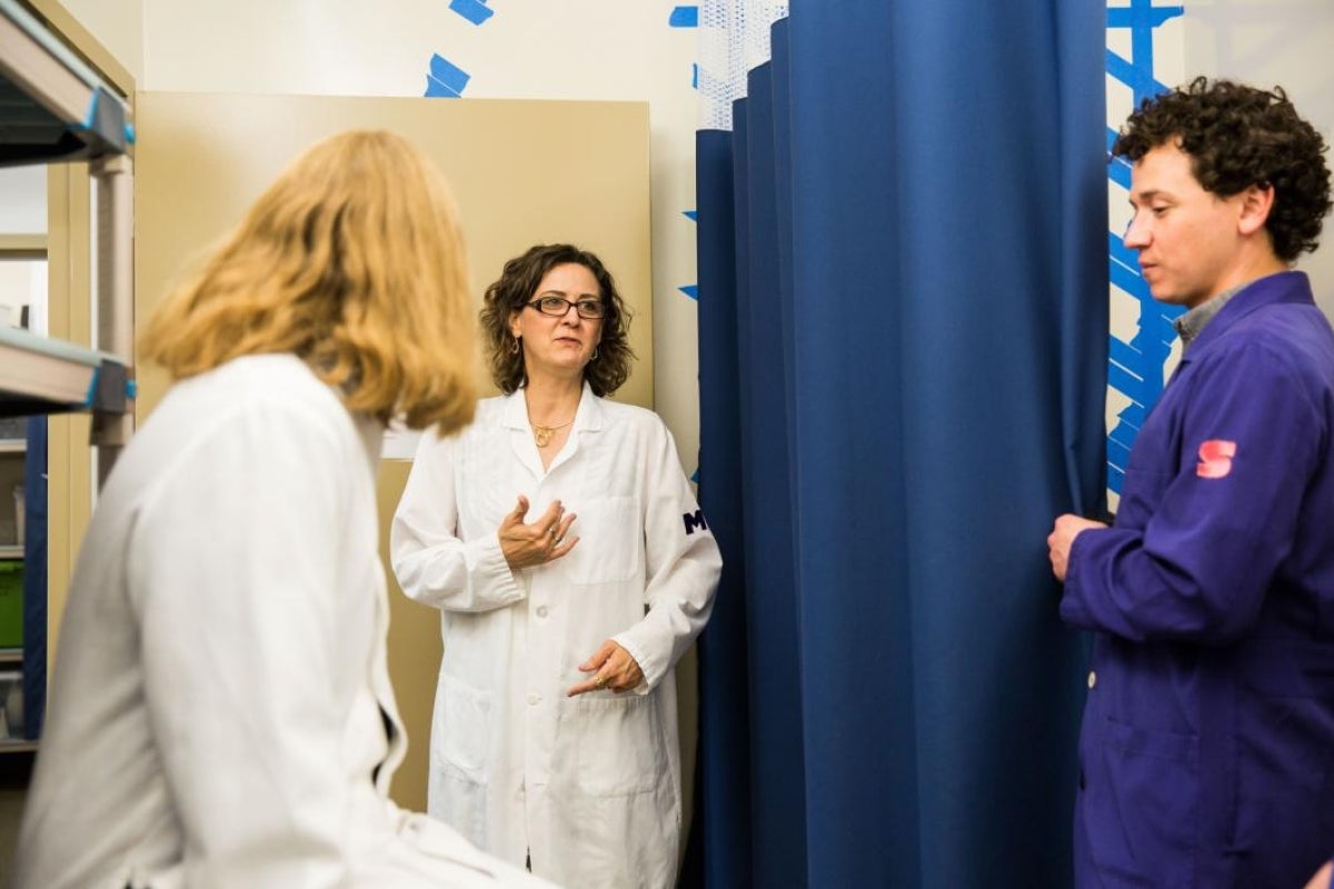 woman in lab with students