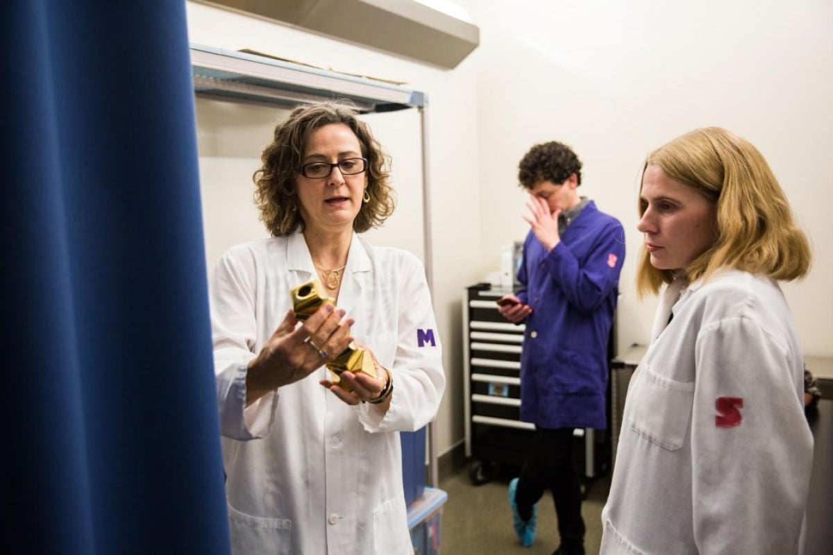 professor in lab with students