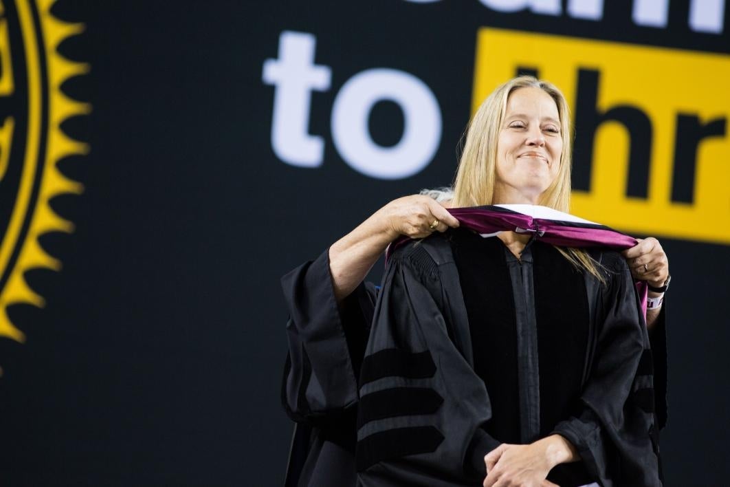 woman getting hooded during commencement