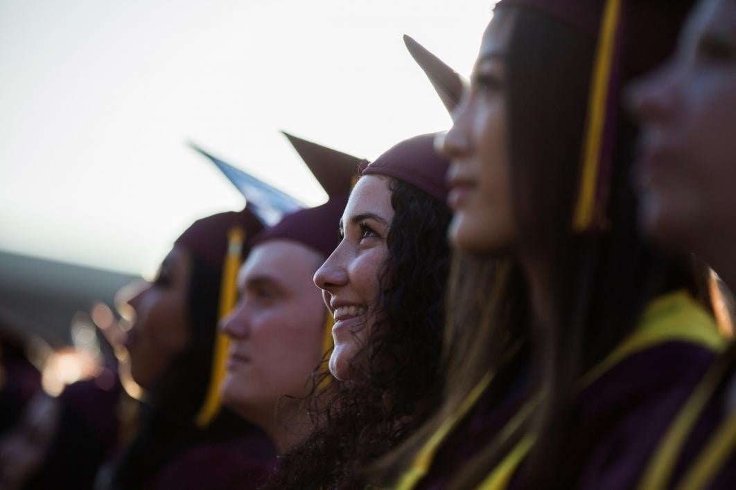 graduates listening to commencement speaker