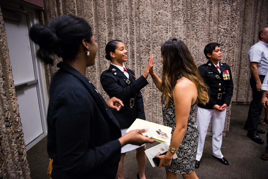 Graduate getting high five from friend