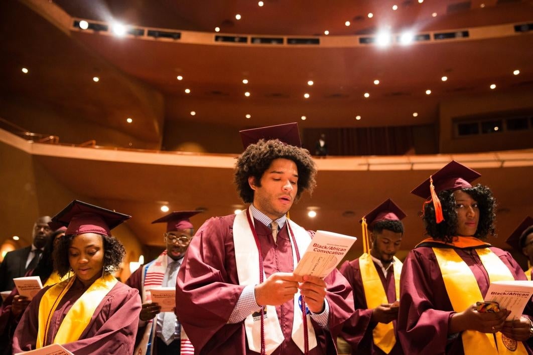 people reading from convocation program