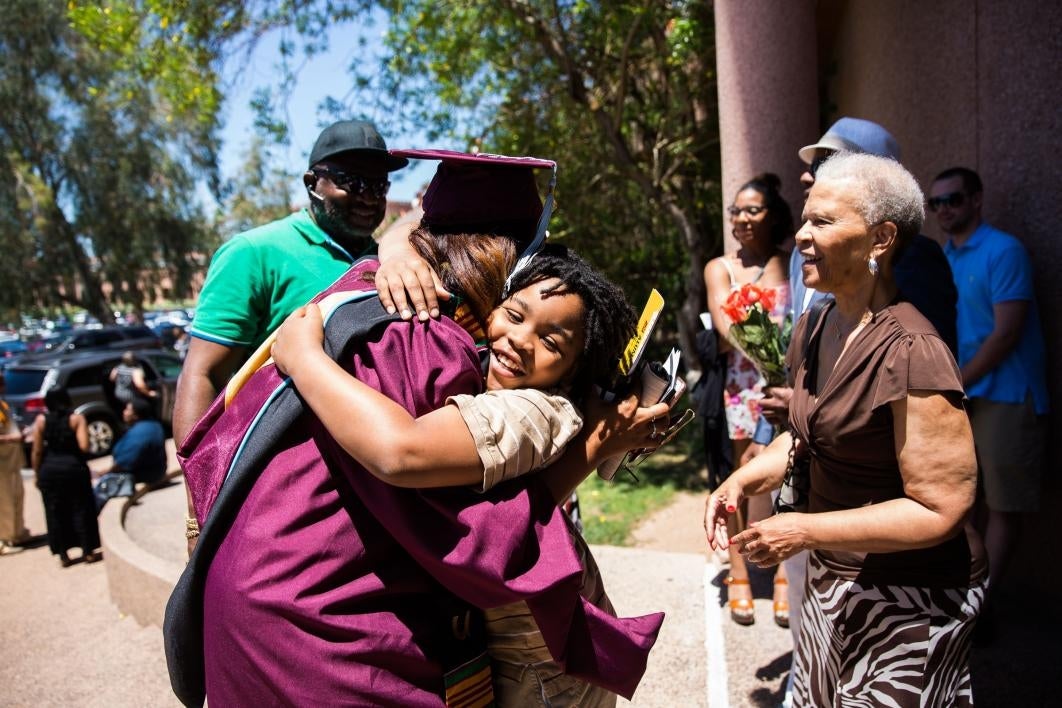 graduate hugging her little brother