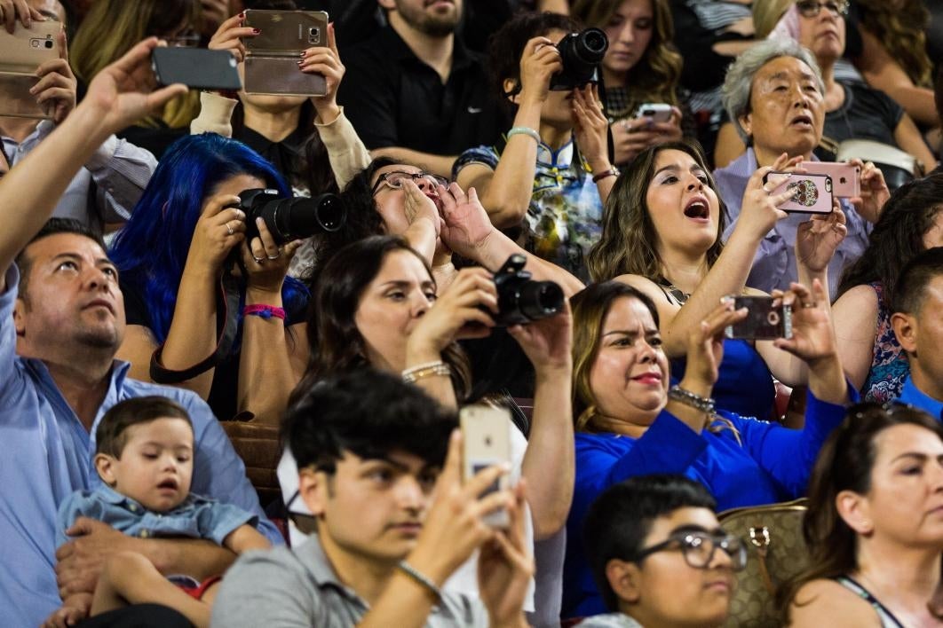 families cheering on their graduates